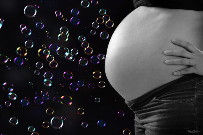 Ventre d'une femme enceinte avec des bulles de savon