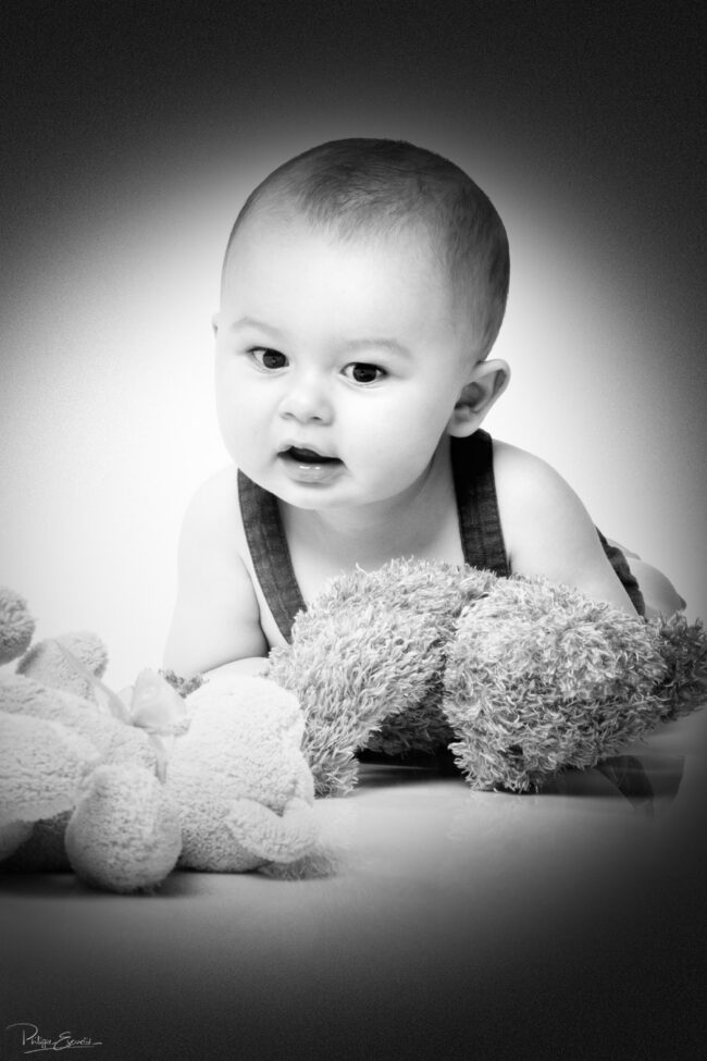 En famille, formule box cadeau ! 8 Un bébé allongé regarde deux peluches au sol