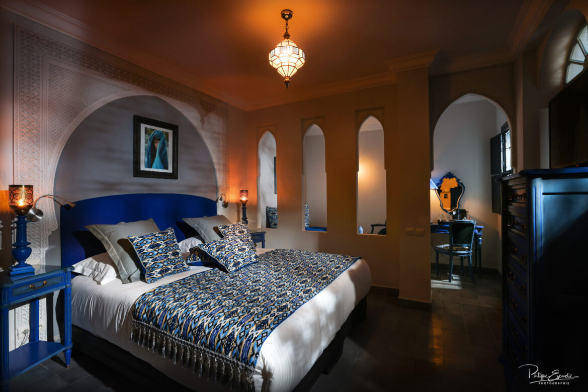 ambiance claire obscure d'une chambre de riad aux tons bleu et blanc.